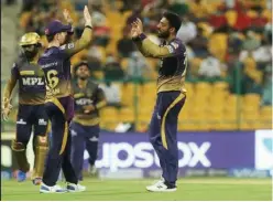  ?? Courtesy: IPL Website ?? ↑
KKR’S Varun Chakaravar­thy celebrates after taking the wicket of Glenn Maxwell of RCB during their IPL match at the Sheikh Zayed Stadium on Monday.