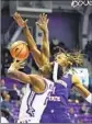  ?? LM Otero Associated Press ?? TCU’S Emanuel Miller battles Northweste­rn State’s Reggie Hill.