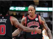  ?? NAM Y. HUH — THE ASSOCIATED PRESS ?? Chicago Bulls guard Coby White, left, celebrates with forward Demar Derozan during the Bulls’ victory over the Atlanta Hawks on Wednesday.