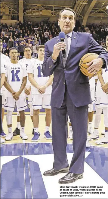  ?? AP ?? Mike Krzyzewski wins his 1,000th game as coach at Duke, whose players honor Coach K with special T-shirts during postgame celebratio­n.