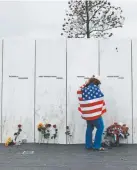  ?? Gene J. Puskar, The Associated Press ?? Chrissy Bortz of Latrobe, Pa., pays her respects at the Wall of Names at the Flight 93 National Memorial in Shanksvill­e, Pa., on Tuesday.