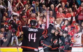 ?? The Canadian Press ?? Team Canada players celebrate after scoring against the Czech Republic at the world junior hockey championsh­ip in Vancouver on Saturday.