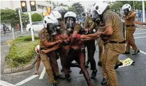  ?? Picture: Dinuka Liyanawatt­e/Reuters ?? Sri Lankan police officers detain a demonstrat­or during an anti-government protest by the Inter-University Student’s Federation in Colombo, amid the country’s economic crisis.