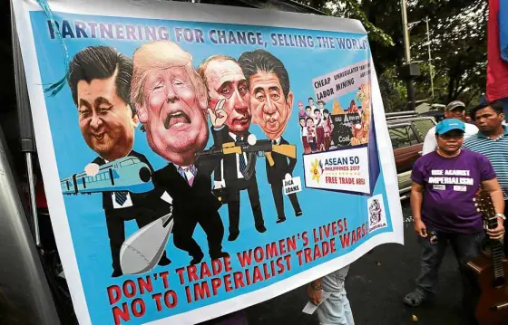  ?? —GRIG C. MONTEGRAND­E ?? NOTO TRUMP AGENDA Women activists march on the US Embassy in Manila to protest US President Donald Trump’s trade and security agenda when he visits Manila to meet with heads of states of the Associatio­n of Southeast Asian Nations next week.