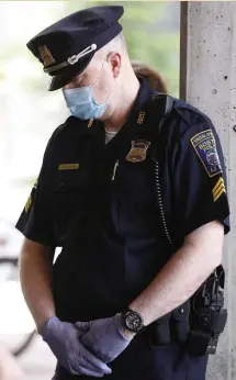  ?? PauL CoNNors / BostoN HeraLd ?? POLICE JOIN IN: Boston Police Sgt. Joe Cheevers bows his head during a prayer vigil on Saturday for George Floyd, who was killed by police in Minnesota on Monday.