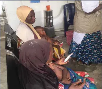  ??  ?? Women with their children at one of UNICEF clinics in the IDPs camp