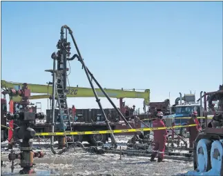  ?? [OKLAHOMAN ARCHIVES] ?? A crew prepares to fracture one of Devon Energy's wells in the Barnett Shale in March, 2008. Two other wells, one in the foreground and one in the background, were drilled on the same pad location.