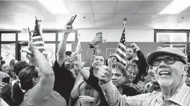  ?? ADRIANA ZEHBRAUSKA­S/THE NEW YORK TIMES ?? Supporters of President Trump pose with his son, Eric, last month in Phoenix. Latinos for Trump organized the event.