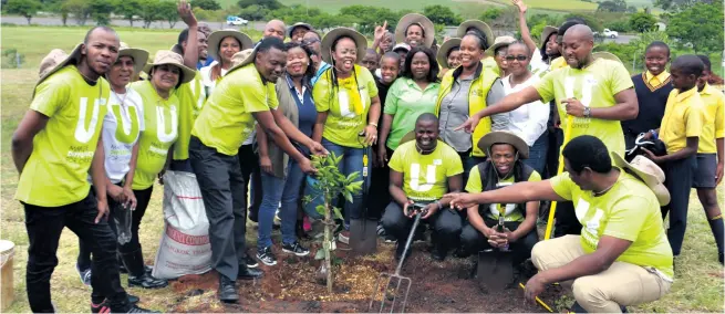  ??  ?? All smiles from the Woolworths team after planting the first fruit tree Muzi Zincume