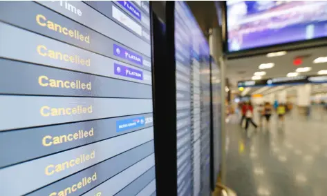  ?? WILFREDO LEE/AP ?? A monitor is shown listing cancelled flights at Miami Internatio­nal Airport in Miami. In addition to residents affected by Hurricane Irma in Florida and the Caribbean, thousands of travellers’ vacation plans have been disrupted by cancelled flights,...