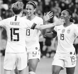  ?? CHRIS CARLSON/AP ?? U.S. forward Megan Rapinoe celebrates with forward Lynn Williams and defender Crystal Dunn after scoring during the Concacaf women’s Olympic qualifying final against Canada Sunday in Carson, Calif.