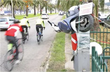  ??  ?? Bicycles ride past a speed camera trashed in Ajaccio on the French Mediterran­ean Island of Corsica, a day after a third nationwide day of demos by the yellow vests. — AFP photo