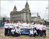  ?? PROVIDED TO CHINA DAILY ?? Staff at Henry Bath in Liverpool show their support for the Belt