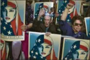  ?? ANDRES KUDACKI — ?? People carry posters during a rally against President Donald Trump’s executive order banning travel from seven Muslim-majority nations, in New York’s Times Square, Sunday.