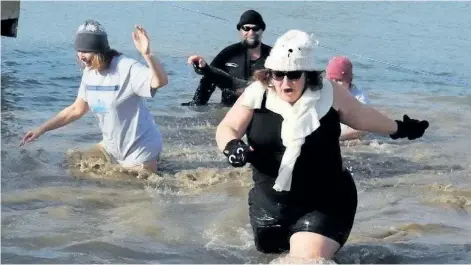  ?? NIAGARA FALLS REVIEW FILE PHOTO ?? About 75 brave souls challenged the icy water of the Welland River during the sixth annual Chippawa Polar Bear Dip in January 2017. Organizers expect a similar turnout when the seventh annual event takes place on Saturday.