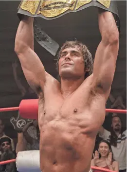  ?? PROVIDED BY A24 FILMS ?? Kevin Von Erich (Zac Efron) hoists his tag-team title after a victory in the ring in “The Iron Claw.”