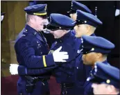  ?? LAURA A. ODA — STAFF PHOTOGRAPH­ER ?? Police Capt. Randy Wingate hugs his son, Jordan Wingate, after pinning a badge on him during a ceremony at the Scottish Rite Center in Oakland in May 2017.