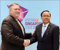  ?? — AFP photo ?? Pompeo (left) shakes hands with Kyaw Tin on the sidelines of the 51st Associatio­n of Southeast Asian Nations (Asean) Ministeria­l Meeting (AMM) in Singapore.