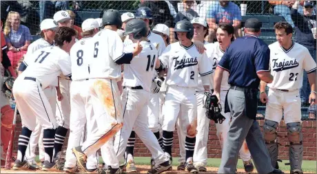  ??  ?? The Gordon Lee Trojans celebrate a two-run homer by Caleb Hopkins (14) during the sixth inning of Game 2 against Clinch County on Saturday. Hopkins’ homer was the third of the inning and the fourth of the game for the Navy-and-White, who swept the...