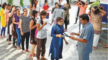  ?? PTI ?? Candidates being checked before appearing for the NEET exam. The exam is open to NRIs but they must travel to one of the test centres in India as the exam is only offered offline.