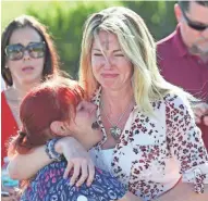  ?? JOEL AUERBACH/AP ?? Parents wait for news after reports of a shooting Wednesday at Marjory Stoneman Douglas High School in Parkland, Fla.