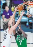  ?? Ashley Landis The Associated Press ?? Raptors center Marc Gasol, left, and Celtics guard Jaylen Brown compete for a rebound in the second half of Boston’s 122-100 win Friday at the Wide World of Sports Complex.