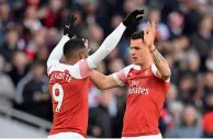  ?? AFP ?? Arsenal’s Granit Xhaka (right) celebrates scoring the opening goal with Lacazette during the EPL match against United. —