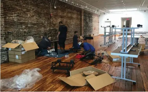  ?? (Special to The Commercial/Deborah Horn) ?? Workers are putting together tables that will fill the second-floor multipurpo­se room at the new ARTSpace on Main. It can serve as classroom or workshop space and more.