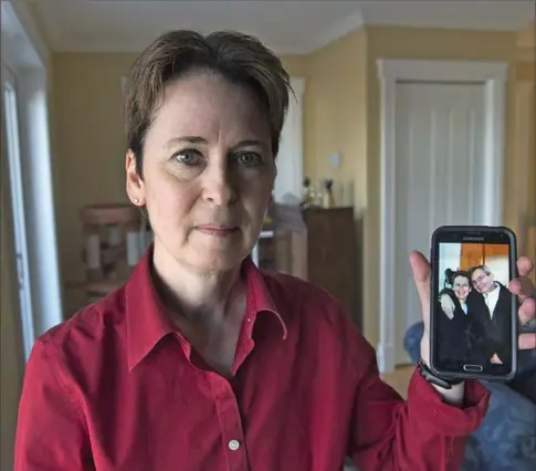  ?? ANDREW VAUGHAN, THE CANADIAN PRESS ?? Kim D’Arcy displays an image of her late husband, Jack Webb, at her home in Bedford, N.S. She still has questions about her husband’s death that are disturbing her sleep and her grief.