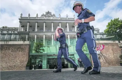  ?? Joe Klamar / AFP ?? Austrian police outside the Palais Coburg Hotel where the Iran nuclear talks meetings are being held in Vienna. Negotiator­s from Iran and major powers are “working hard” to secure a nuclear deal but “political will” is still needed, an Iranian diplomat...