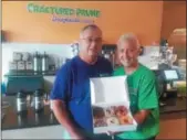  ?? GARY PULEO — DIGITAL FIRST MEDIA ?? At the newly opened Fractured Prune Doughnuts in Audubon, owners Steve and Kathie Kotch hold a batch of freshly made hot doughnuts.