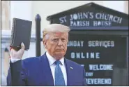  ?? (File Photo/AP/Patrick Semansky) ?? President Donald Trump holds a Bible on June 21 as he visits outside St. John’s Church across Lafayette Park from the White House in Washington.
