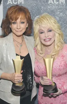  ?? RICK DIAMOND/GETTY IMAGES ?? Music legends Reba McEntire, left, and Dolly Parton attend the
11th annual Academy of Country Music Honors in Nashville Wednesday.