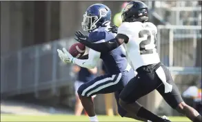  ?? Stew Milne / Associated Press ?? UConn receiver Heron Maurisseau catches a pass as Purdue safety Sanoussi Kane defends during the first half on Saturday in East Hartford