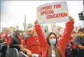  ?? Francine Orr Los Angeles Times ?? MEMBERS of United Teachers Los Angeles and Local 99 of Service Employees Internatio­nal Union hold a rally in solidarity last week at Grand Park.