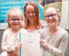  ?? Kara and Jade Long holding mom Jennifer’s brand-new certificat­e at the awards ceremony in The Rose Hotel. ??