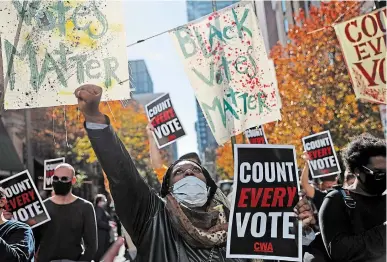  ?? REBECCA BLACKWELL THE ASSOCIATED PRESS ?? Zhanon Morales, 30, raises her fist as demonstrat­ors call for all votes be counted during a rally in Philadelph­ia Thursday.