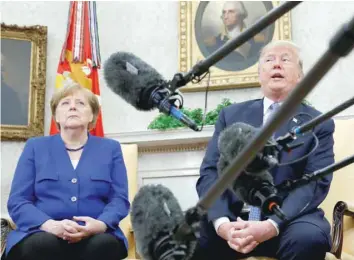  ??  ?? President Donald Trump meets with German Chancellor Angela Merkel in the White House Oval Office in Washington. — Reuters