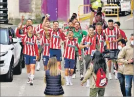  ??  ?? Atletico players celebrate outside the Jose Zorilla stadium after winning La Liga.