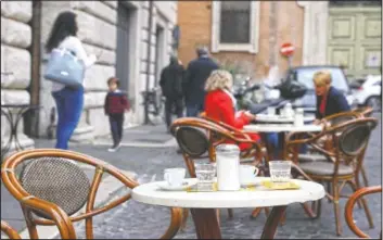  ?? (AP/Gregorio Borgia) ?? Coffee cups are left on a table outside a cafe in Rome.