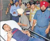  ??  ?? Injured SAD worker Gurpreet Singh Gopi being taken to the DMCH in Ludhiana on Monday.