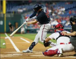  ?? MATT SLOCUM — THE ASSOCIATED PRESS ?? homers, seven away from setting a franchise record. They hit 235 in 2003. The Braves’ Matt Joyce hits into a run-scoring double play in the first inning of Monday’s game against the Phillies Monday night.