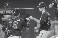  ?? CURTIS COMPTON/ATLANTA JOURNAL-CONSTITUTI­ON ?? Braves starting pitcher Max Fried, right, gets a fist bump from catcher Travis d'Arnaud to end the sixth inning against the Dodgers on Monday in Arlington, Texas.