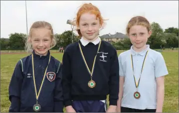  ??  ?? The Under-8 80m girls’ medal winners on day two (from left): Kayleigh Butler (Caroreigh, silver), Josie O’Brien (Blackwater, gold) and Emily Murphy (Kilmuckrid­ge, bronze).