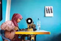  ??  ?? Hawa Adan Hassan, 23 year-old, university student, uses a sewing machine at her home in
Mogadishu, Somalia.