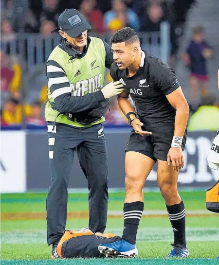  ??  ?? Richie Mo’unga required attention after copping a late tackle in Perth on Saturday.