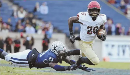  ?? AP PHOTO ?? TRIPPED UP: Harvard’s Aaron Shampklin is tackled by Yale’s Foye Oluokun yesterday at the Yale Bowl in New Haven, Conn., during the 134th edition of The Game.