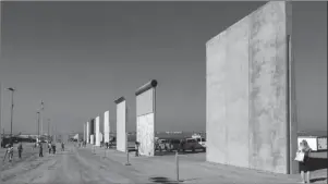  ?? The Associated Press ?? PROTOTYPES: This Oct. 26, 2017, file photo shows prototypes of border walls in San Diego. President Donald Trump is not giving up on his demands for $5.7 billion to build a wall along the U.S.-Mexico border, saying a physical barrier is central to any strategy for addressing the security and humanitari­an crisis at the southern border. Democrats argue that funding the constructi­on of a steel barrier along roughly 234 miles will not solve the problems.