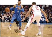  ??  ?? OKLAHOMA CITY THUNDER guard Russell Westbrook (#0) drives to the basket in front of Houston Rockets guard Eric Gordon (#10) during the fourth quarter at Chesapeake Energy Arena.