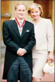  ??  ?? In this June 25, 2004 file photo, journalist Harold Evans poses for a photo with his wife Tina Brown, after he was knighted by the Prince of Wales for service to journalism. Evans, the charismati­c publisher, author and muck
raker, has died at 92. (AP)